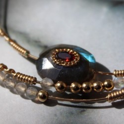 Focus sur les ornements du set dulce et sa labradorite incrustée d'un grenat ceinturée d'une chaine dorée