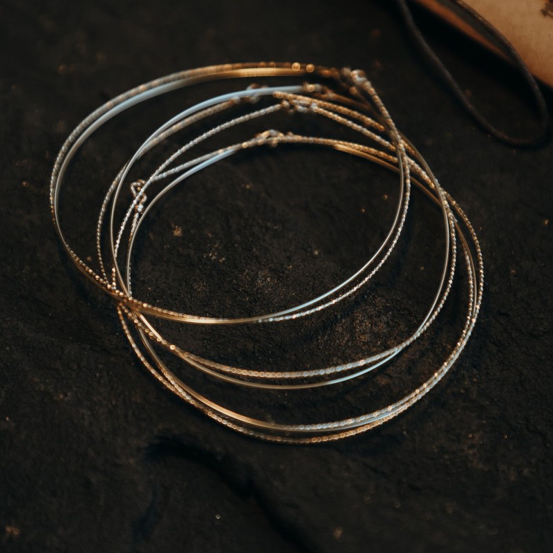 Semainier Shine composé de 7 joncs en or laminé 14 carats Éclats Nomades.